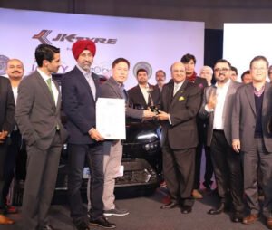 Dr. Raghupati Singhania presenting the ICOTY award to Kia Carens